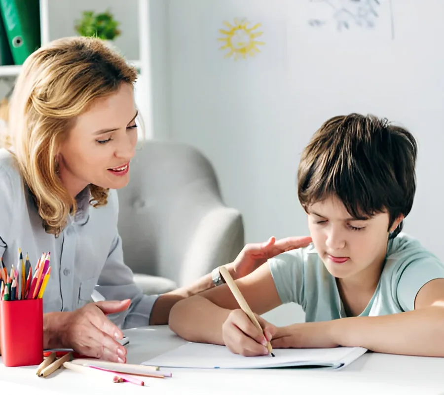 A tutor helping a child with writing